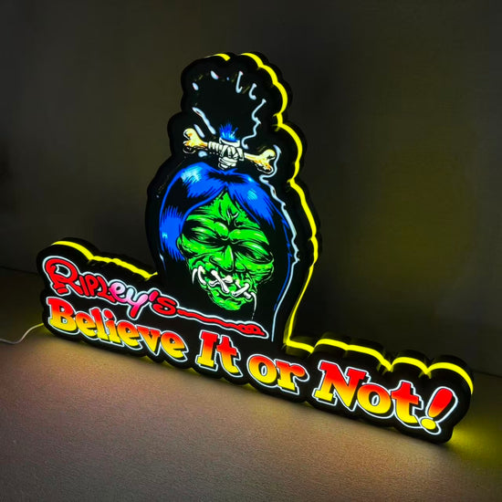 Neon sign with a skull design and 'Believe It or Not!' text on a dark background